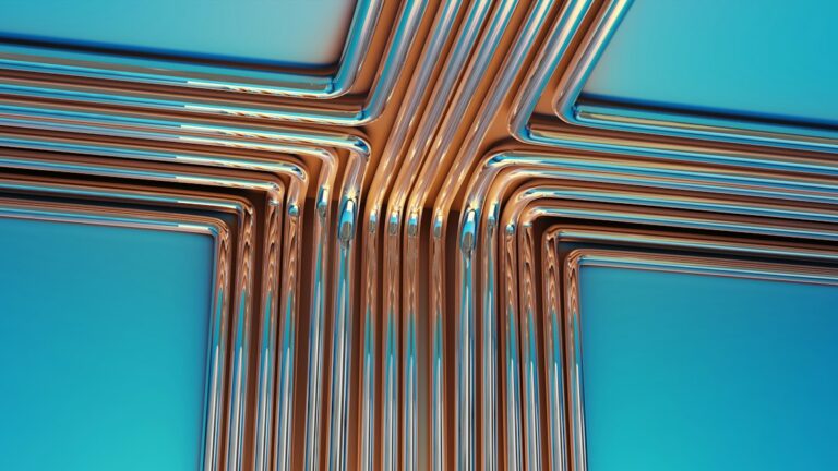 Copper plumbing pipe fittings arranged on blue background