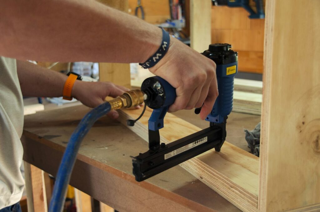Worker operating a power tool on wood