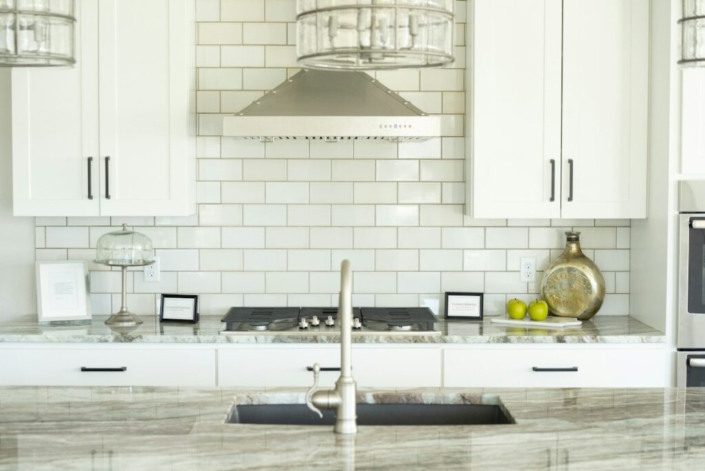 Bright modern kitchen with white cabinets and tile backsplash