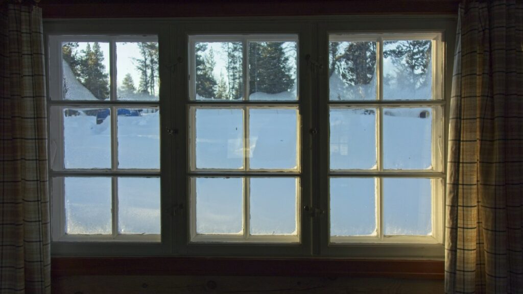 House window overlooking snow outdoors